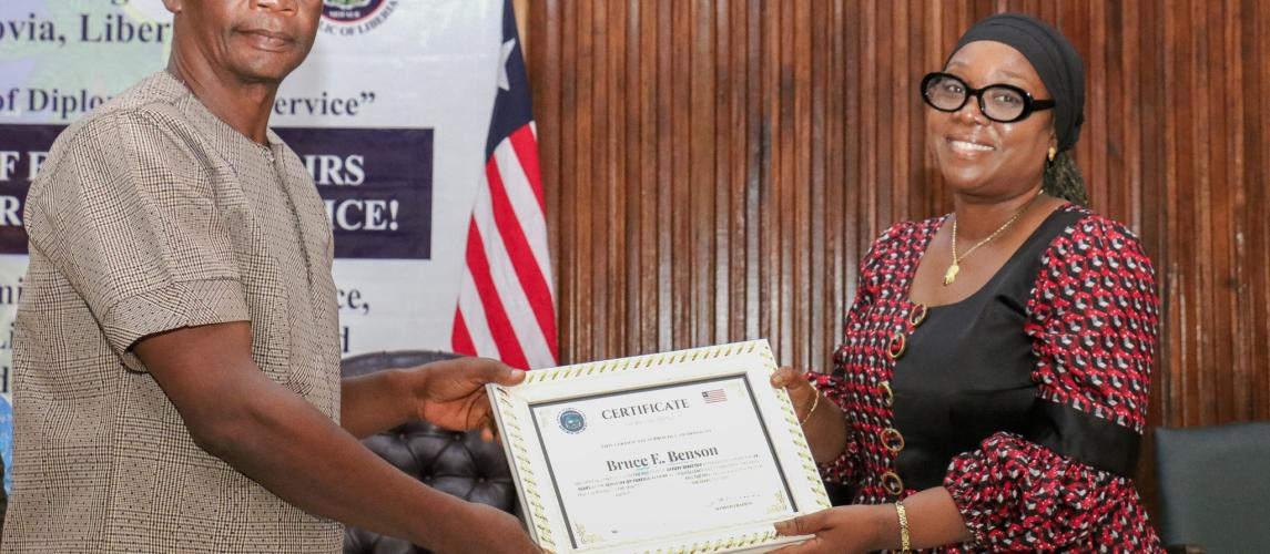 The Minister of Foreign Affairs, Her Excellency Sara Beysolow Nyanti, certificates a retiree The Minister of Foreign Affairs, Her Excellency Sara Beysolow Nyanti, certificates a retiree