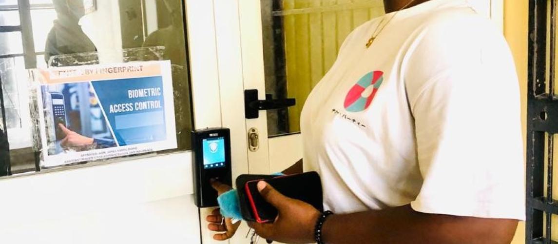 MOT Employee at the Biometric Signing Machine  