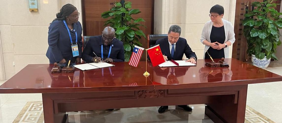 (L-R) Commissioner of the Liberia Maritime Authority, Cllr. Neto Z. Lighe and China's Minister of Transport, Li Xiaopeng at the signing ceremony on September 5th as their aids looked on.