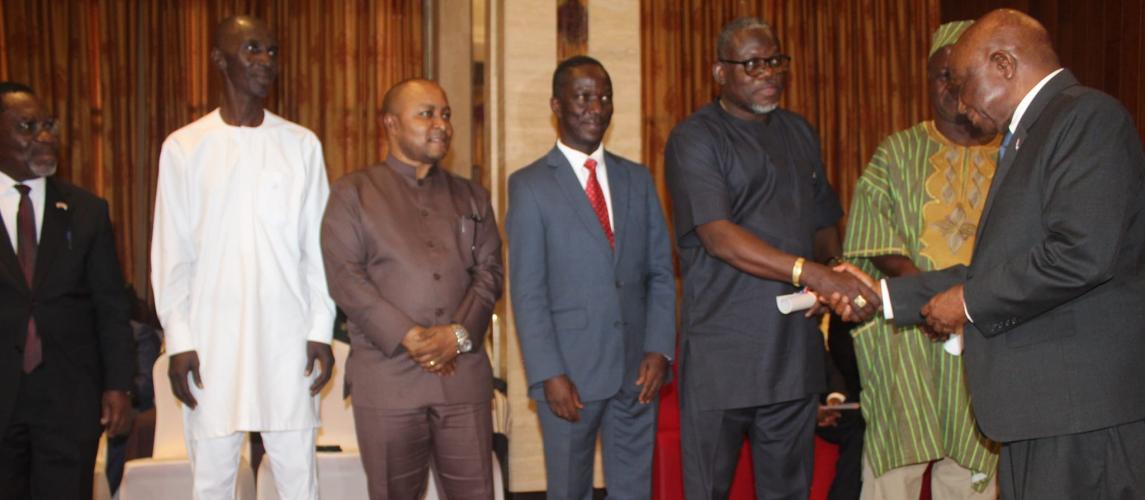 His Excellency President Joseph N. Boakai shakes hands with Hon. Jerolinmek Piah.